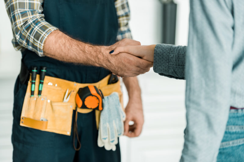 customer and maintenance working shaking hands